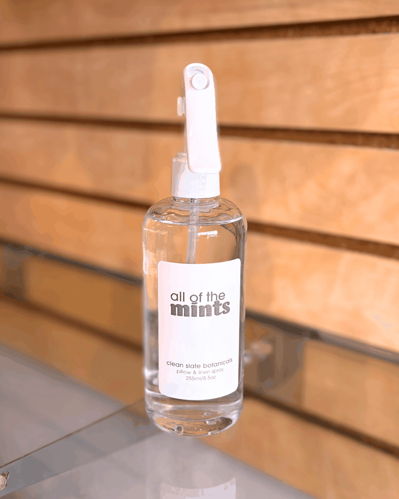 All Of The Mints Linen Spray in a clear bottle with a white sprayer and minimalist label reading “all of the mints”