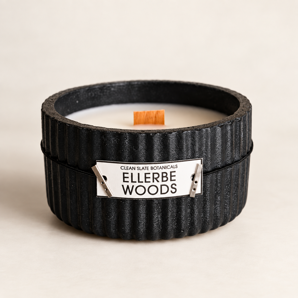 Ellerbe Woods Candle in a black artisan concrete ribbed vessel with wood wick and white soy wax