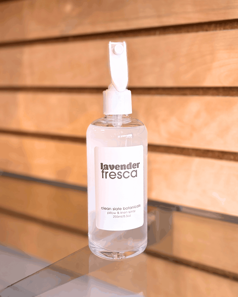 Lavender Fresca Linen Spray in a clear bottle with a white spray nozzle and lavender fresca label