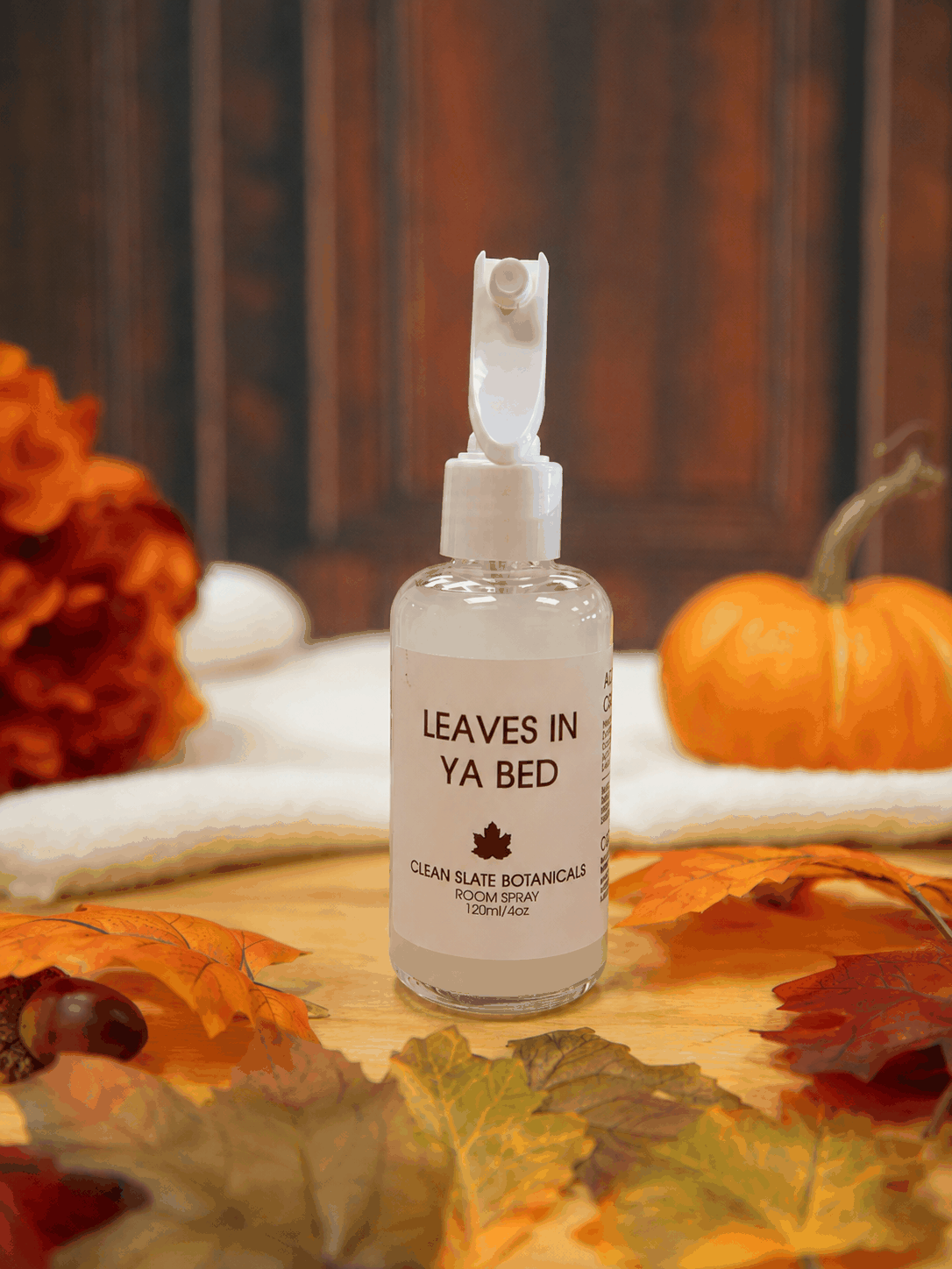 Leaves In Ya Bed room spray in a clear glass bottle with a white spray top and cream label, featuring a leaf motif