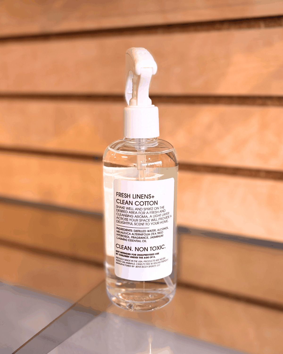 Louisiana Linens clear plastic room spray bottle with white trigger cap and a label featuring fresh linens and clean cotton scent details