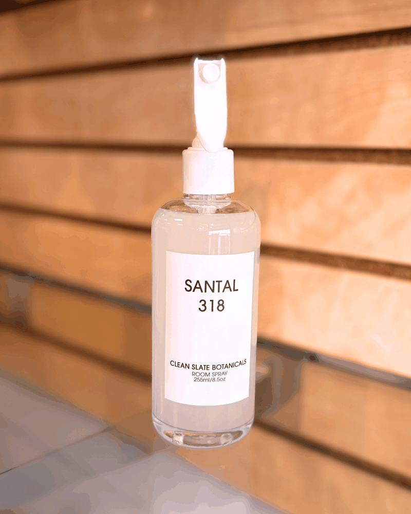 Santal 318 Room Spray in a clear bottle with a white label and fine mist sprayer, filled with pale liquid