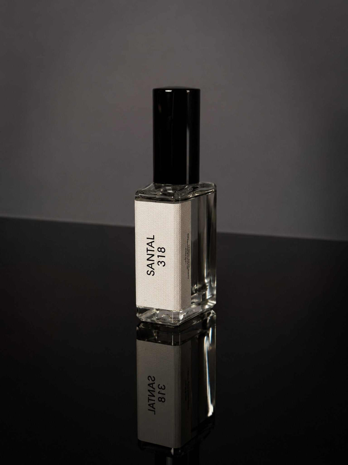 Santal 318 Wearable Fragrance in a clear rectangular glass bottle with a black cap and cream label
