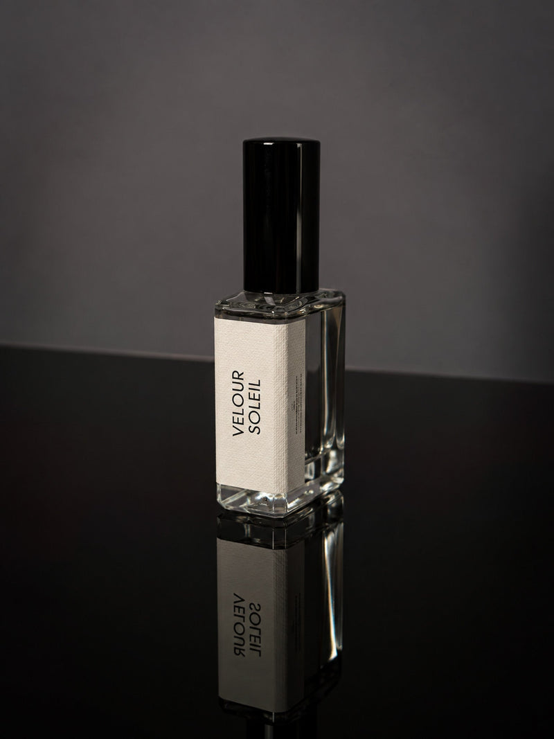 Velour Soleil wearable fragrance in a clear rectangular glass bottle with a black cap and cream label